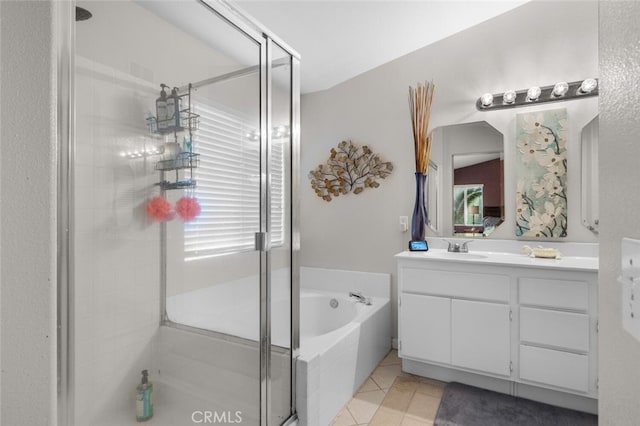 bathroom featuring tile patterned floors, vanity, and shower with separate bathtub