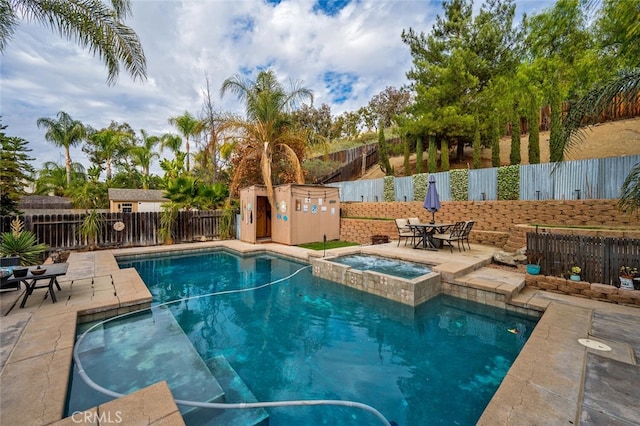 view of pool featuring an in ground hot tub and a patio