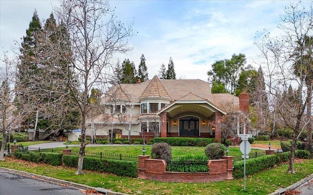 view of front of home featuring a front yard and french doors