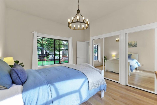 bedroom featuring light hardwood / wood-style flooring and a notable chandelier