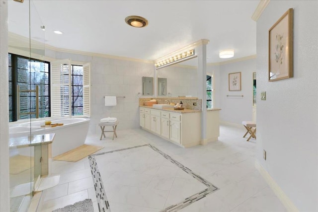 bathroom featuring a tub, vanity, and ornamental molding