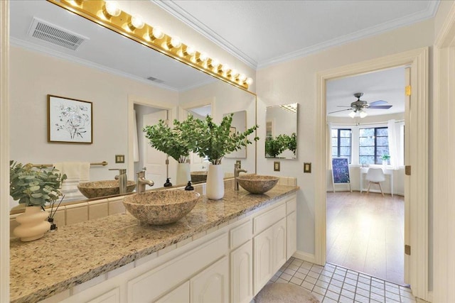 bathroom with ceiling fan, tile patterned floors, vanity, and ornamental molding