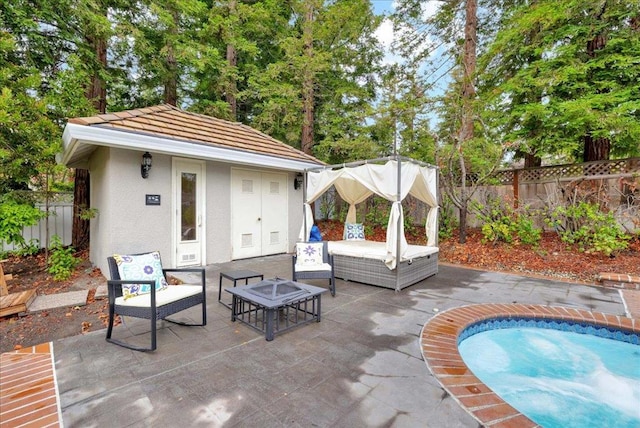 view of patio / terrace with outdoor lounge area, a swimming pool, and an outdoor structure