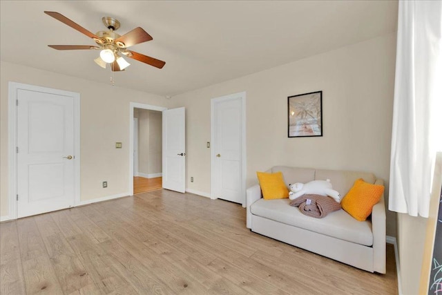 living area featuring ceiling fan and light hardwood / wood-style flooring