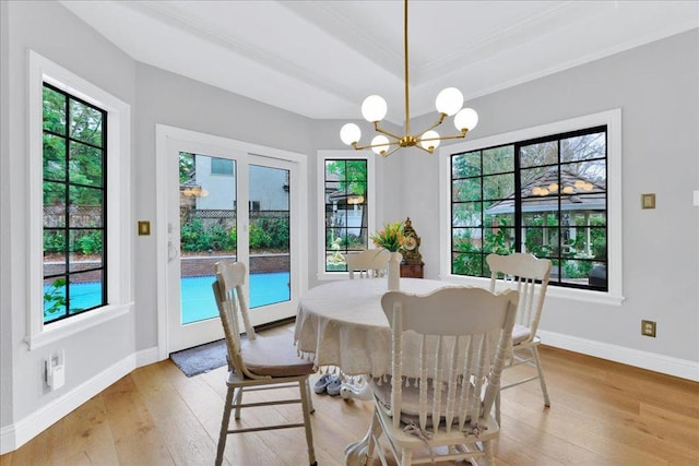 dining area with a notable chandelier and light hardwood / wood-style flooring