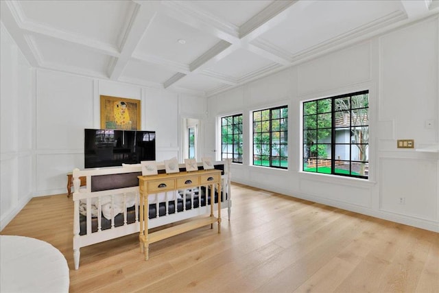 interior space featuring beamed ceiling, coffered ceiling, and light hardwood / wood-style flooring