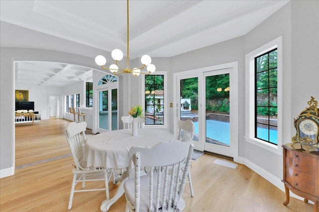 dining area with light wood-type flooring and a chandelier