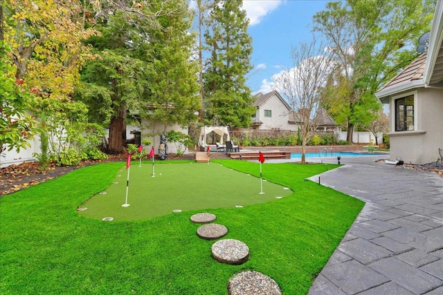 view of property's community with a swimming pool and a patio