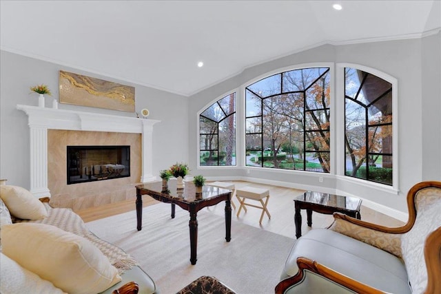 living room featuring crown molding and a tiled fireplace