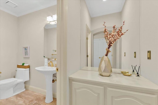 bathroom featuring toilet and ornamental molding