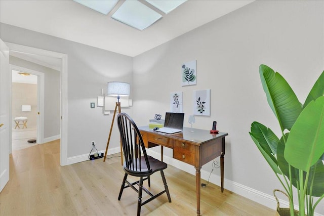 office with light wood-type flooring