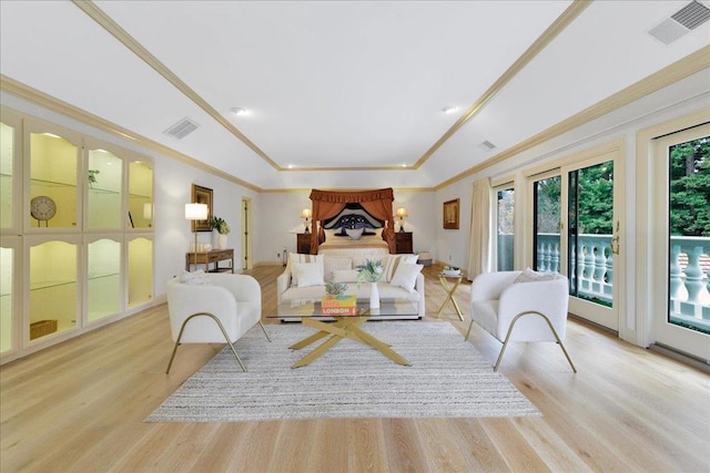 living room featuring ornamental molding and light hardwood / wood-style floors