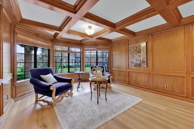 sitting room featuring beam ceiling, wood walls, coffered ceiling, and light hardwood / wood-style flooring