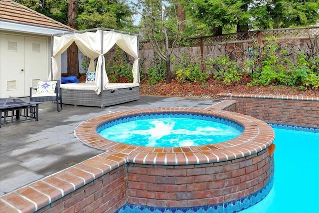 view of pool with a patio and an in ground hot tub