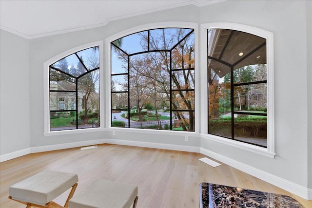 interior space featuring crown molding and hardwood / wood-style floors