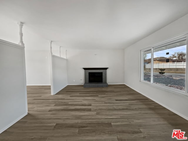 unfurnished living room with a fireplace and dark hardwood / wood-style flooring