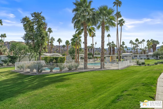 view of community with a yard and a pool