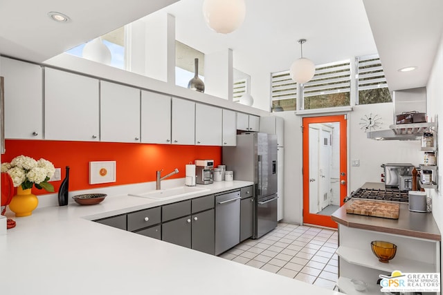 kitchen featuring gray cabinetry, sink, hanging light fixtures, light tile patterned flooring, and appliances with stainless steel finishes