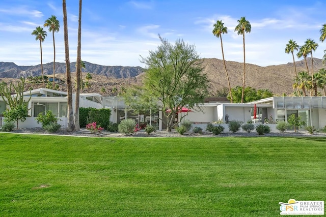 exterior space with a lawn and a mountain view