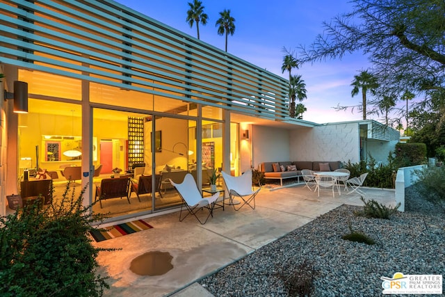 patio terrace at dusk with outdoor lounge area