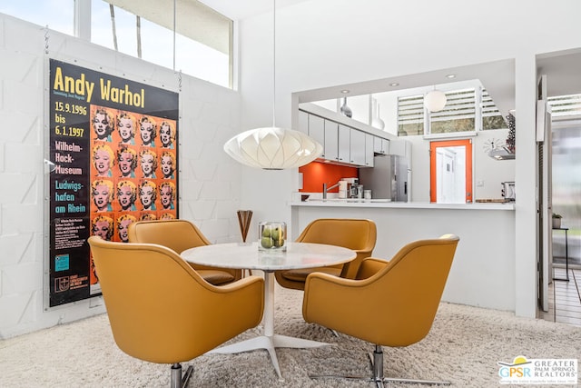 dining area with a high ceiling