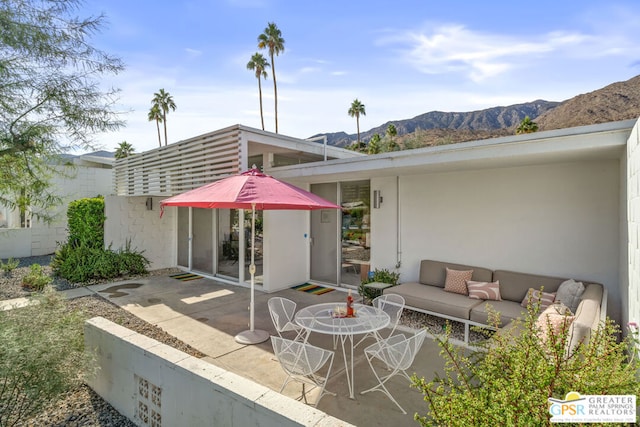 exterior space with a mountain view and outdoor lounge area