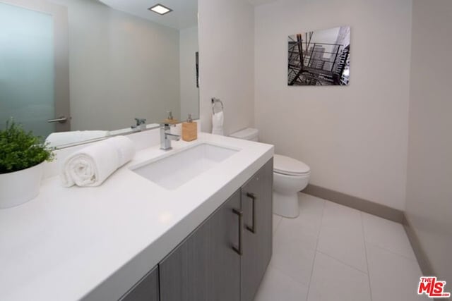 bathroom with tile patterned floors, vanity, and toilet