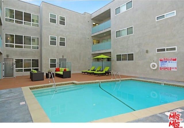 view of swimming pool with a patio and an outdoor hangout area