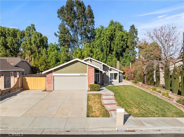 ranch-style home featuring a front lawn and a garage