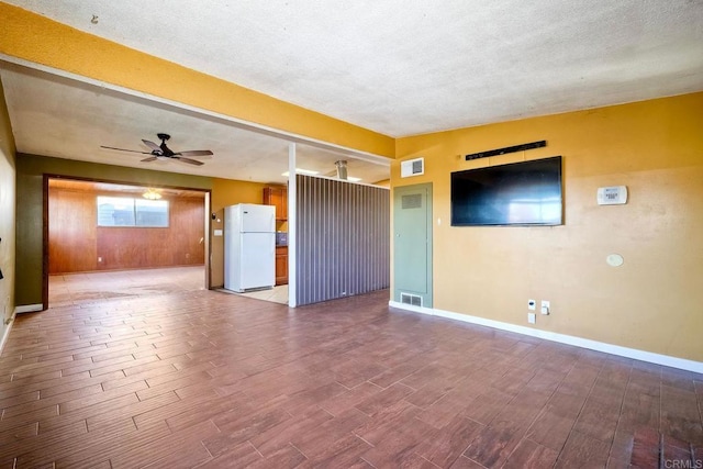 unfurnished living room with a textured ceiling and ceiling fan