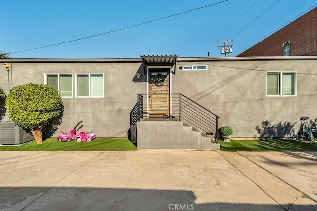 exterior space featuring central air condition unit and a patio