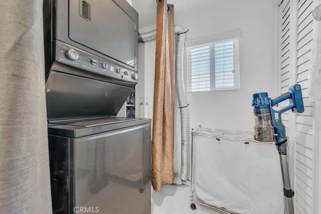 clothes washing area with stacked washer / drying machine