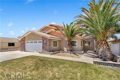 mediterranean / spanish-style house featuring a front lawn and a garage