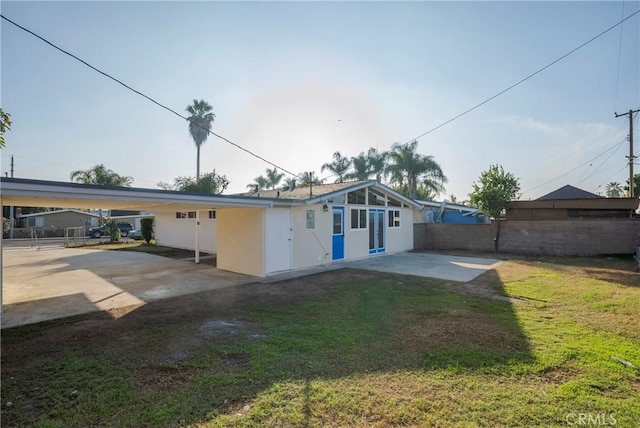 rear view of house with a yard and a patio