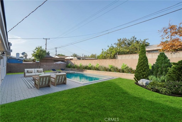 view of pool featuring outdoor lounge area, a yard, and a patio