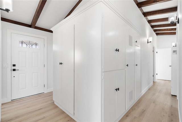 hallway with vaulted ceiling with beams and light wood-type flooring