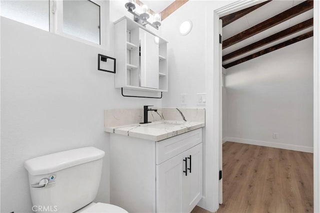 bathroom with vaulted ceiling with beams, toilet, vanity, and hardwood / wood-style flooring