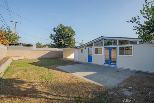 back of property with a patio