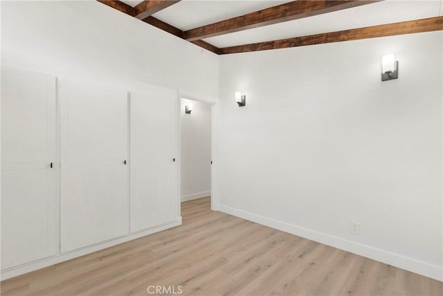 interior space with beamed ceiling and light wood-type flooring