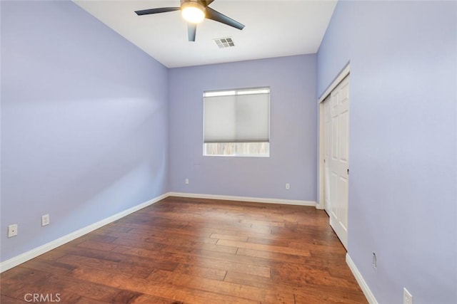 unfurnished room featuring dark hardwood / wood-style floors and ceiling fan