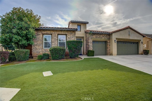 mediterranean / spanish house with a garage and a front lawn