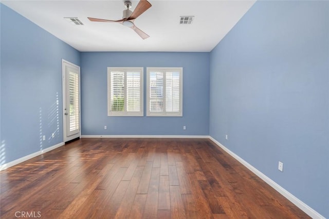 unfurnished room with ceiling fan and dark hardwood / wood-style flooring