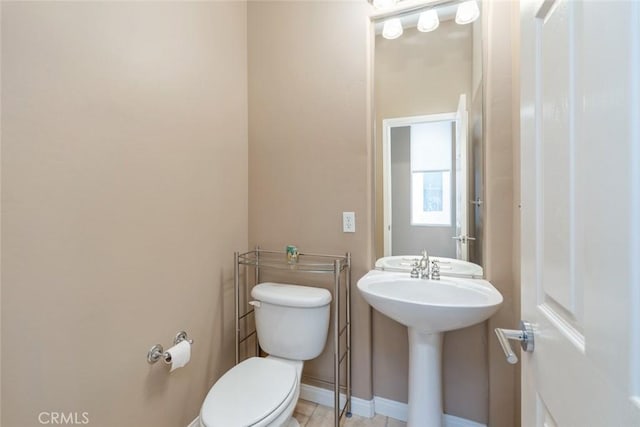 bathroom with tile patterned floors, sink, and toilet