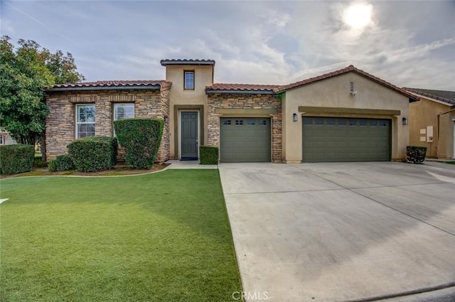 mediterranean / spanish house with a front yard and a garage