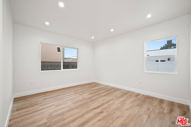 empty room with light hardwood / wood-style floors