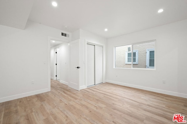 empty room with light hardwood / wood-style floors