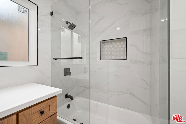 bathroom with tile walls and tiled shower / bath combo