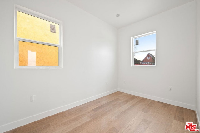 spare room featuring light wood-type flooring