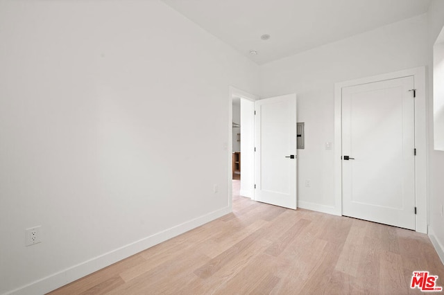 unfurnished bedroom with light wood-type flooring