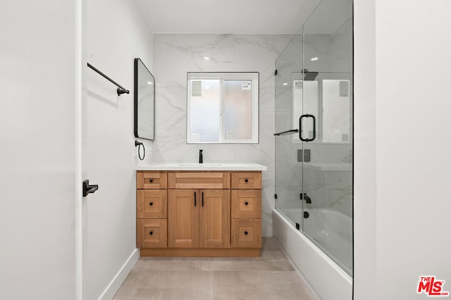 bathroom with vanity and combined bath / shower with glass door